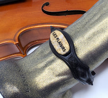 Load image into Gallery viewer, Closeup view near the base of a Night at the Opera colorway King Noire insertable toy next to a violin on a white background