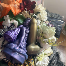 Load image into Gallery viewer, Photo by Tiana GlittersaurusRex of a Lady and Countess sized Jasmine's Garden penetratable stroker along side a Countess FEMDOM insertable in color Night at the Opera. These toys are arranged on a variety of sensual texture and color; beautiful fabrics, flower petals, and soft faux furs. There is sunlight coming into the room from the upper right corner.