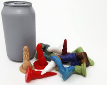 Load image into Gallery viewer, A small pile of various colors and designs of the silicone mini charms with a soda can for scale on a white background