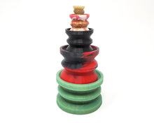 Load image into Gallery viewer, Four sizes of Double-Sided Suction Cups from Lust Arts stacked on top of each other with a charm mini suction cup on top of the stack