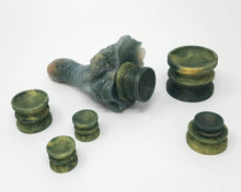 Load image into Gallery viewer, Six Double-Sided Suction Cups from Lust Arts in a deep green and pale gold color in a range of three sizes and a Mosswood Dragon with a suction cup