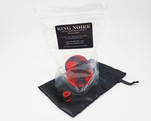 Load image into Gallery viewer, A packaged King Noire Double-Sided Suction Cup and mini charm version on a small black satin bag on a white background