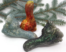 Load image into Gallery viewer, Group image of all three original colors for the Mosswood Dragon fantasy-themed adult toy on a white background with an evergreen tree branch