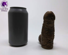 Load image into Gallery viewer, A Frank's Monster insertable sits next to a soda can on a white background.