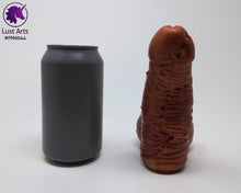 Load image into Gallery viewer, A Frank's Monster insertable sits next to a soda can on a white background.