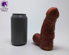Load image into Gallery viewer, A Frank's Monster insertable sits next to a soda can on a white background.