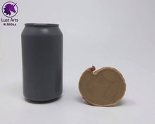 Load image into Gallery viewer, Photo of the underside of a Lust Burster insertable toy next to a soda can for scale on an off-white background