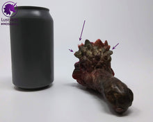 Load image into Gallery viewer, Preview photo (with arrows pointing to bubble flaws) rotating around a pre-made Mosswood Dragon adult toy next to a standard size soda can for scale
