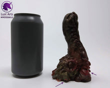 Load image into Gallery viewer, Preview photo (with arrows pointing to bubble flaws) rotating around a pre-made Mosswood Dragon adult toy next to a standard size soda can for scale