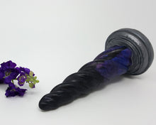 Load image into Gallery viewer, A Twilight color Unicorn Horn insertable toy on its side with purple flowers on a white background
