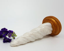 Load image into Gallery viewer, A Sunlight color Unicorn Horn insertable toy on its side with purple flowers on a white background