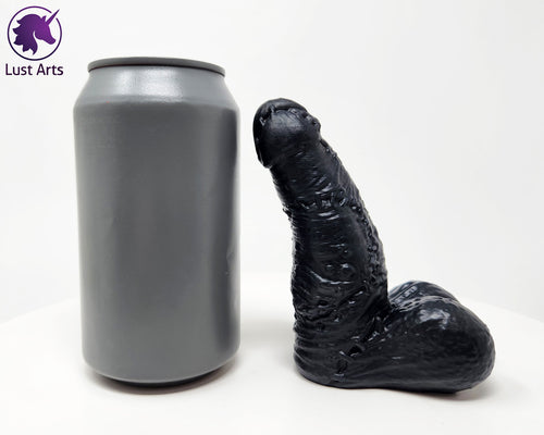 Frank's Monster adult toy next to a soda can for scale