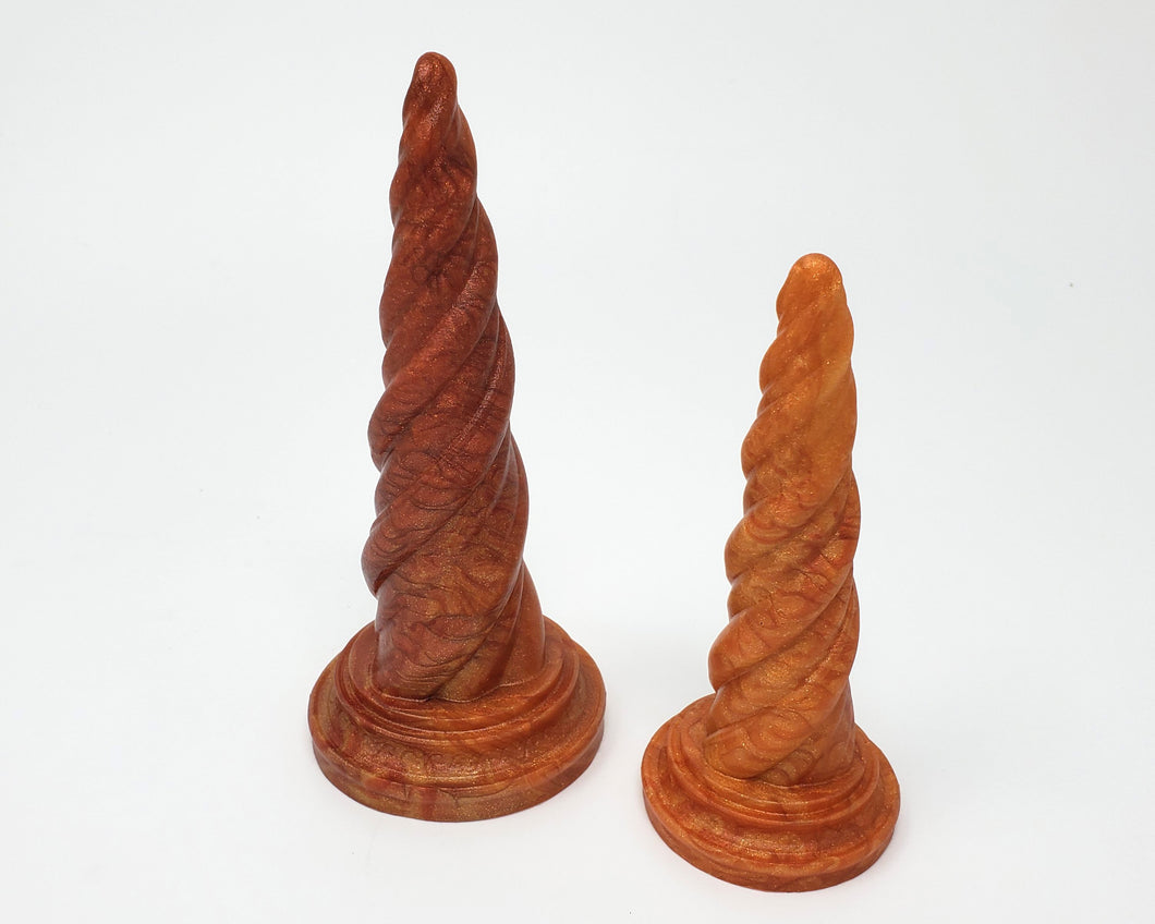 Two Unicorn Horn dildos in special event color Fiery Maple on a white background