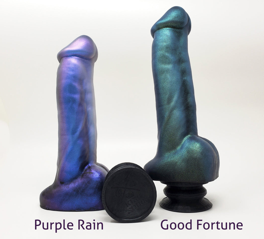 Side view of two King Noire dual-density insertable adult toys with two Double-Sided Suction Cups on an off white background