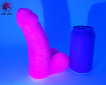 Load image into Gallery viewer, A Frank&#39;s Monster insertable sits next to a soda can on a white background. The whole picture is lit with UV light, showing that there is a UV reaction in the pigment. It glows bright pink.
