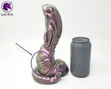 Load image into Gallery viewer, A Lust Burster insertable sits next to a soda can on a white background. There is a circle around the flaw near the base. It is a shallow dent in the toy.
