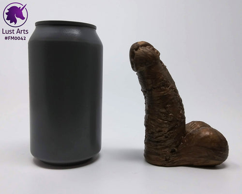 A Frank's Monster insertable sits next to a soda can on a white background.