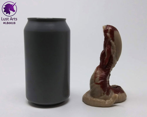 Photo of a Lust Burster insertable toy next to a soda can for scale on an off-white background