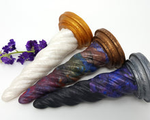 Load image into Gallery viewer, Three different Original Colors of Unicorn Horn insertable toys on their sides with purple flowers on a white background
